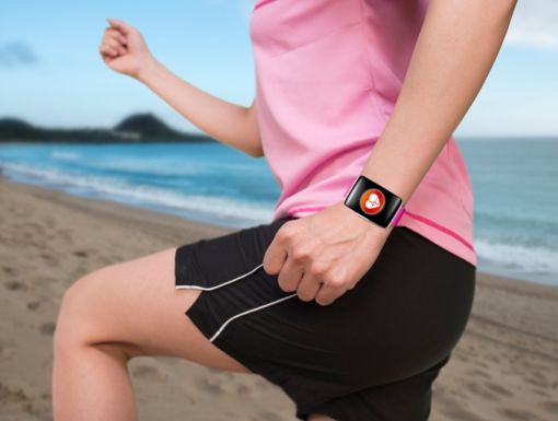 Woman Exercising On Beach Wearing Watchband Touchscreen
