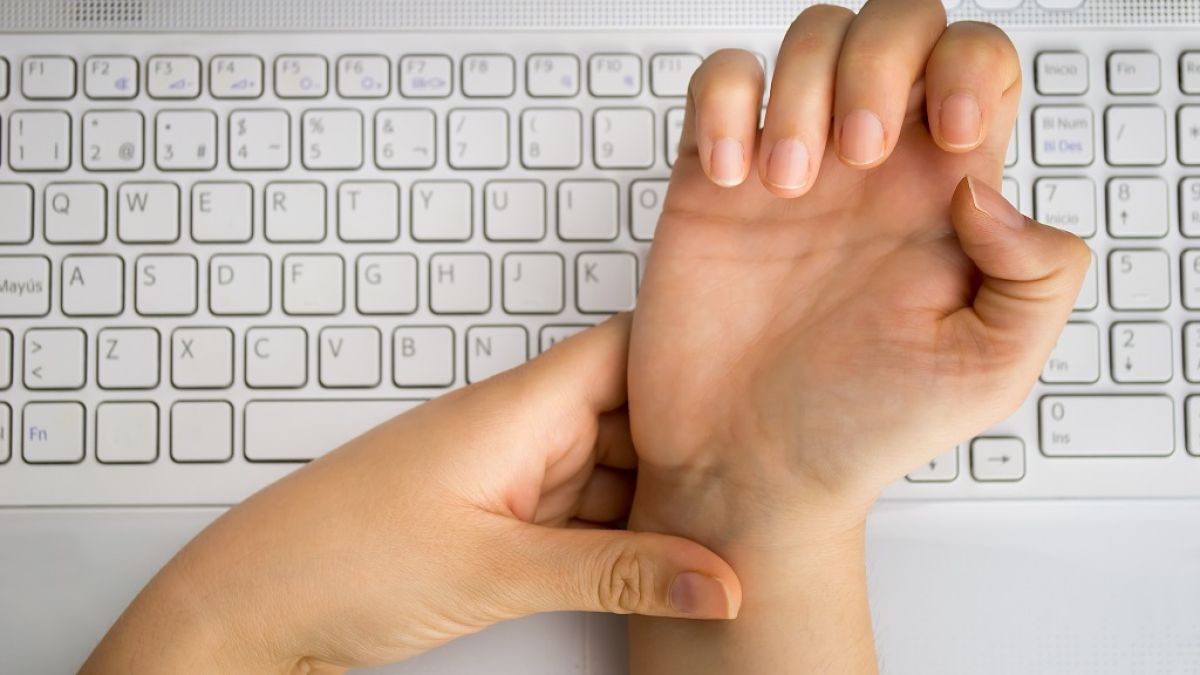 woman clutching her wrist