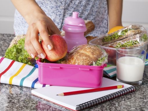 woman packing healthy lunch in a lunchbox
