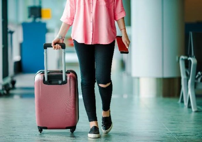 Airplane Passenger With Boarding Pass And Baggage Scaled