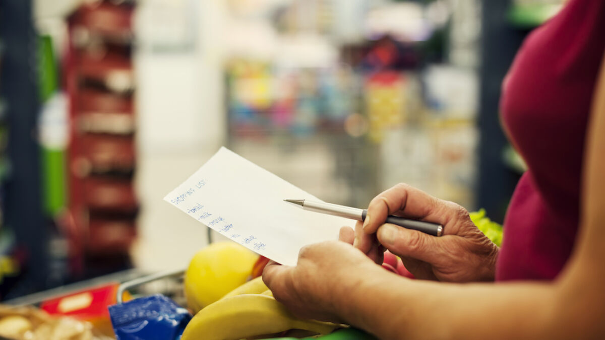 Woman with a checklist at a grocery store