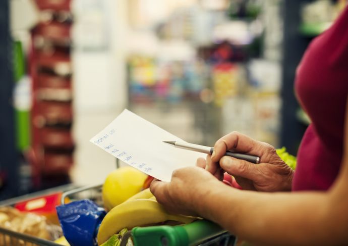 Woman with a checklist at a grocery store