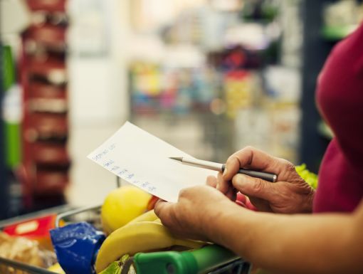 Woman with a checklist at a grocery store