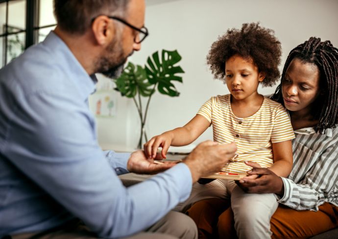 Kid sitting on mom lap during therapy