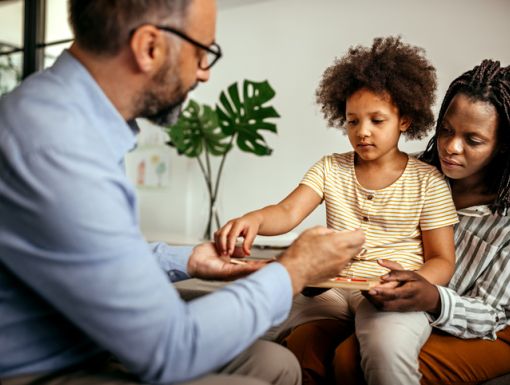 Kid sitting on mom lap during therapy