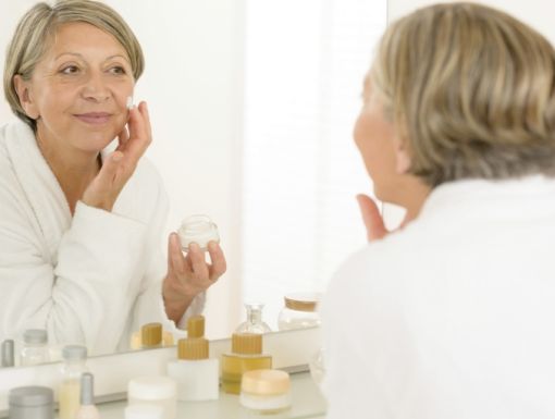 Woman with Wrinkles Looking In Mirror