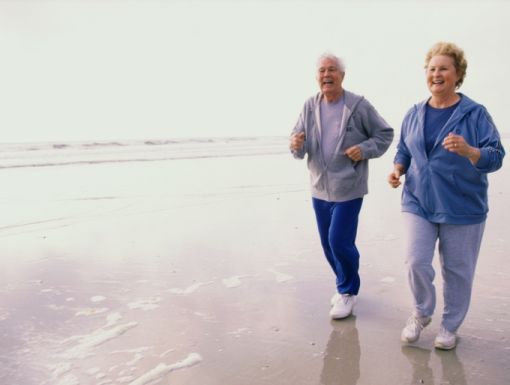 122413055 Senior Couple Jogging On Beach