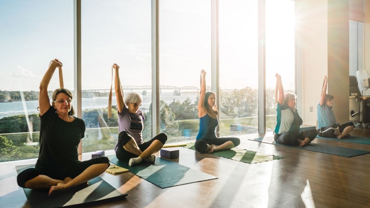 yoga class in sunny room with lots of windows