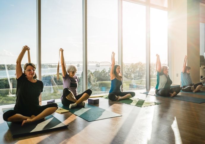 yoga class in sunny room with lots of windows