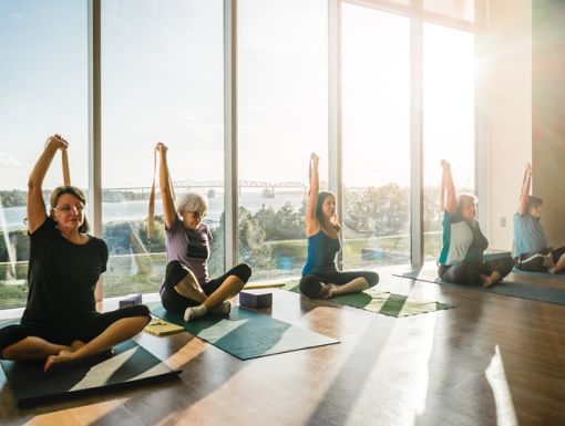 yoga class in sunny room with lots of windows