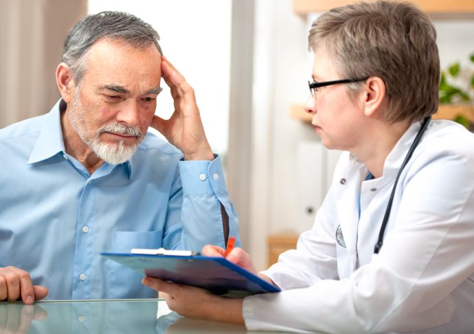man speaking with doctor about lung cancer screening