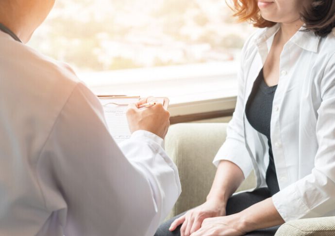 Doctor talking with female patient