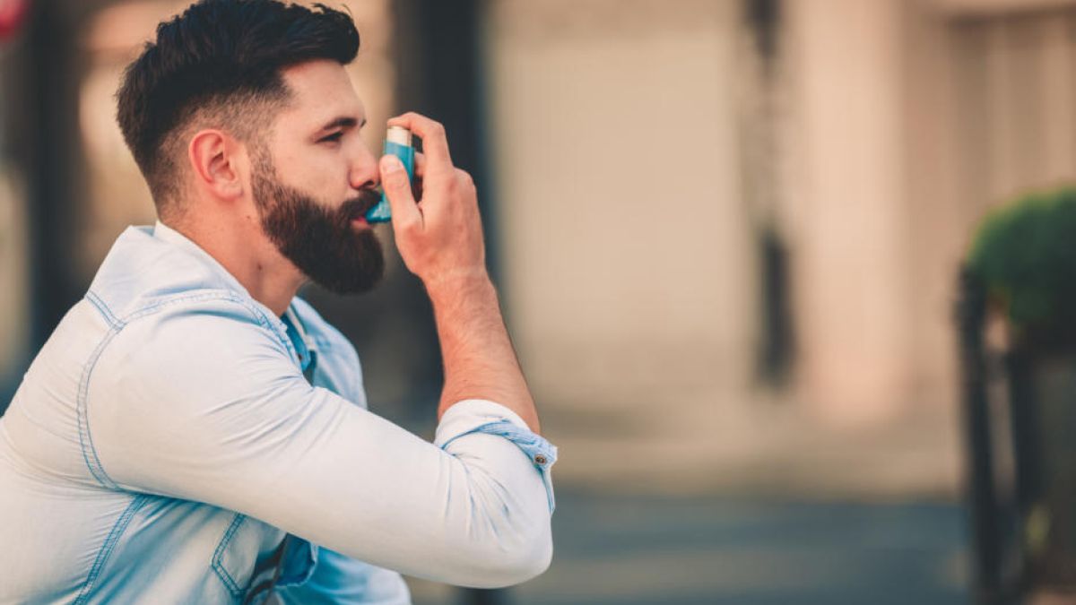 Man using inhaler for asthma