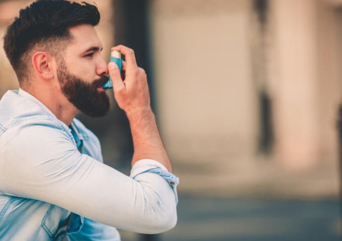 Man using inhaler for asthma