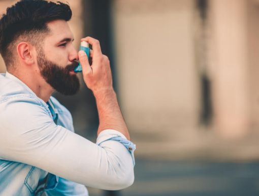 Man using inhaler for asthma