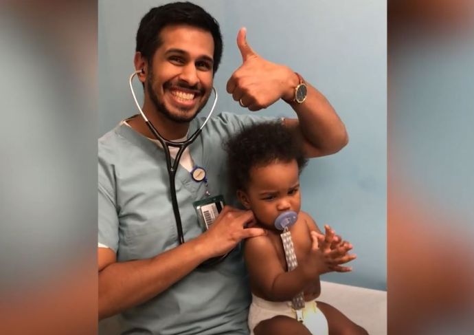 Pediatrician Nicholas Algu, MD, with a patient during a checkup