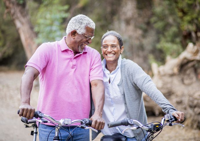 Older black couple riding bikes