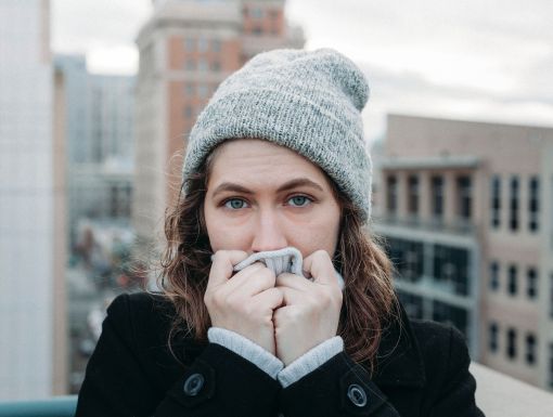 woman bundled up with hat and scarf in cold weather