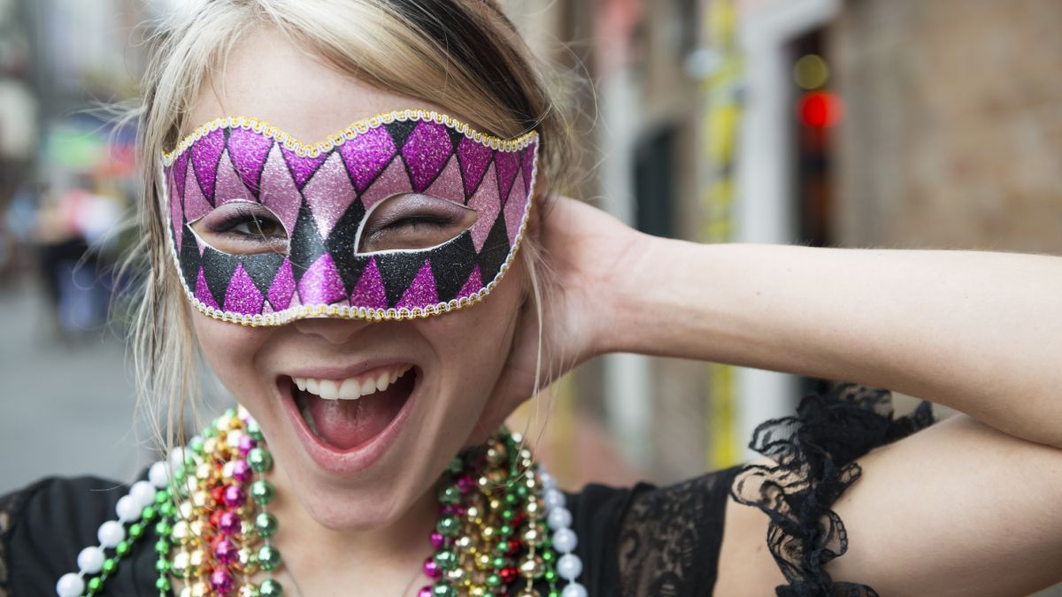 Picture of a woman wearing a Mardi Gras mask