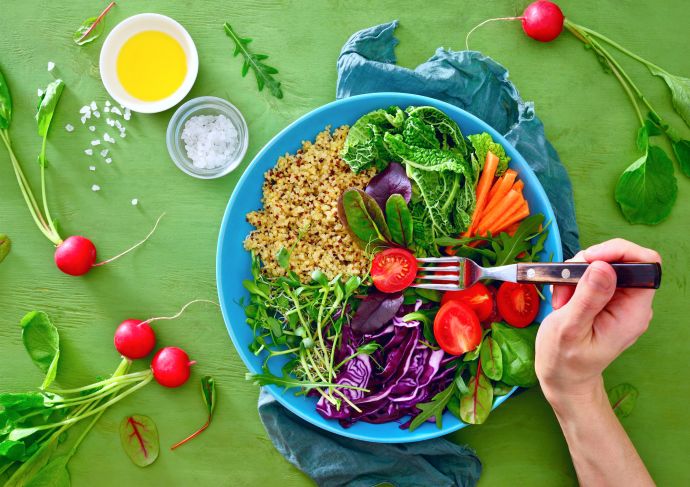 Bowl full of whole foods, including fruits and veggies