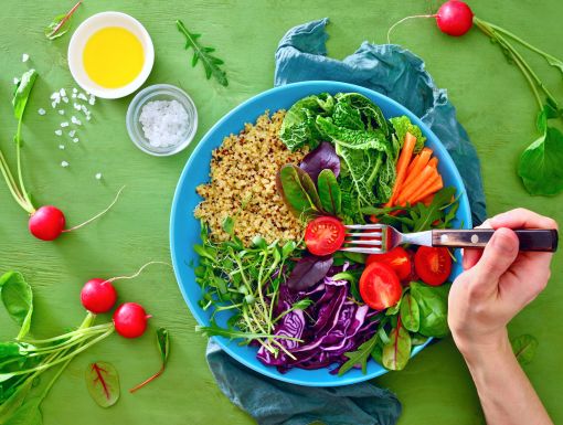 Bowl full of whole foods, including fruits and veggies