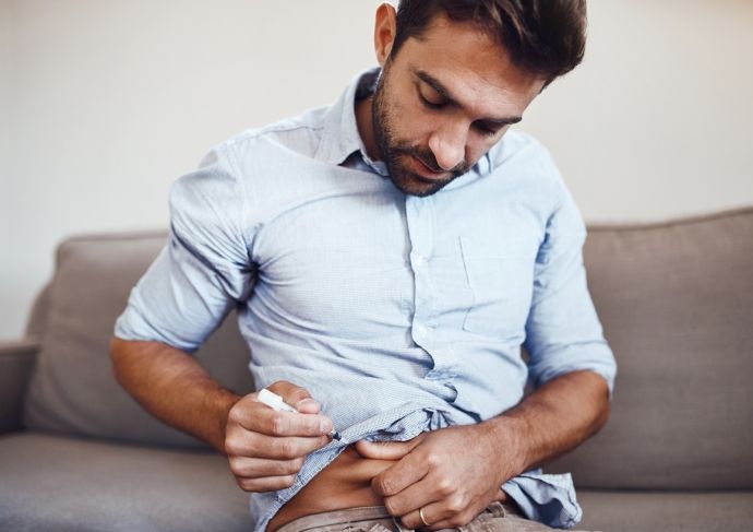 Man injecting hormones into stomach