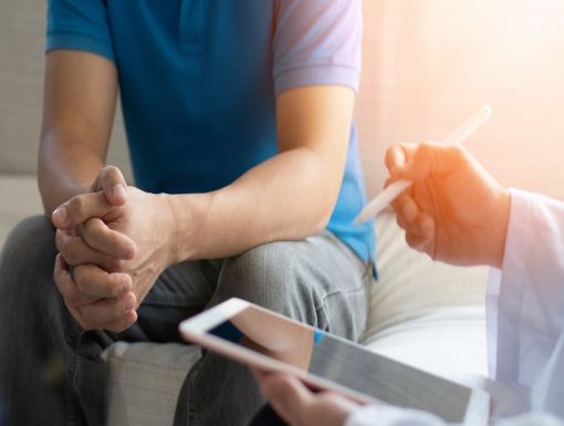 Man talking to female doctor about penis shrinkage