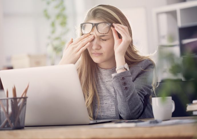 young woman with PTSD sitting at computer