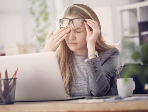 young woman with PTSD sitting at computer