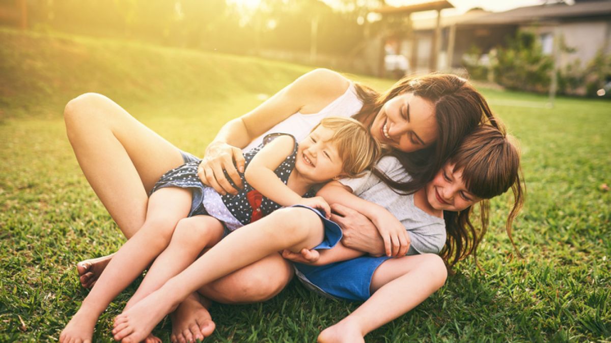 mother playing with children outside