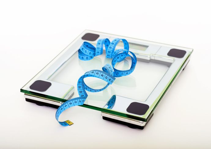 a bathroom scale with a tape measure on top of it