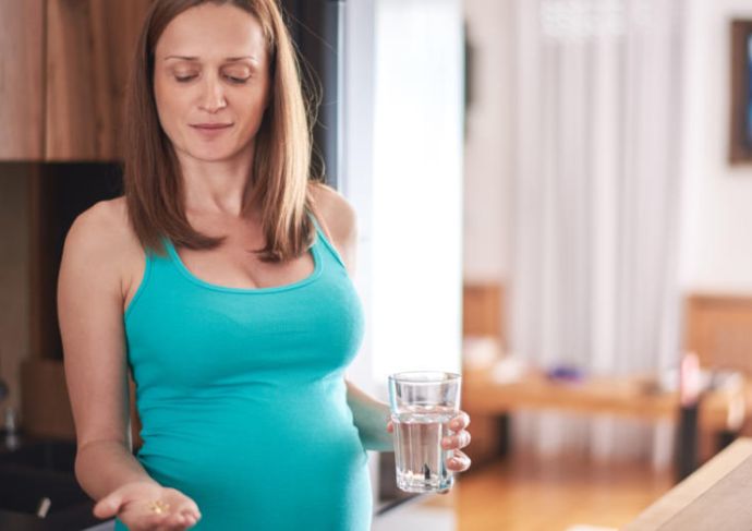 Pregnant woman taking the best prenatal vitamins