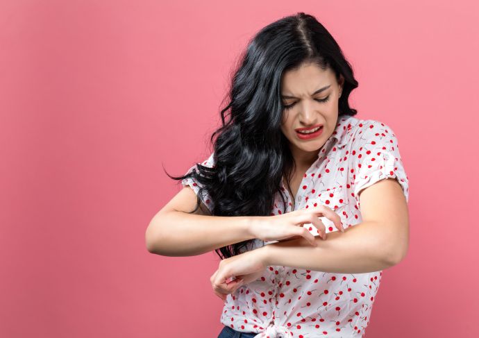 Woman Itching Arm Getty Images 1044939258
