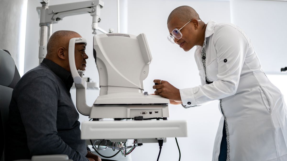 Man-getting-his-eyes-checked-by-eye-doctor