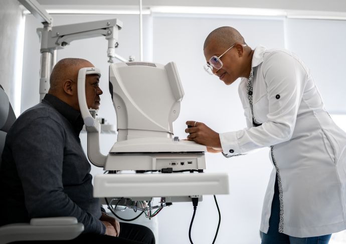 Man-getting-his-eyes-checked-by-eye-doctor