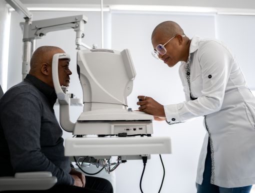 Man-getting-his-eyes-checked-by-eye-doctor