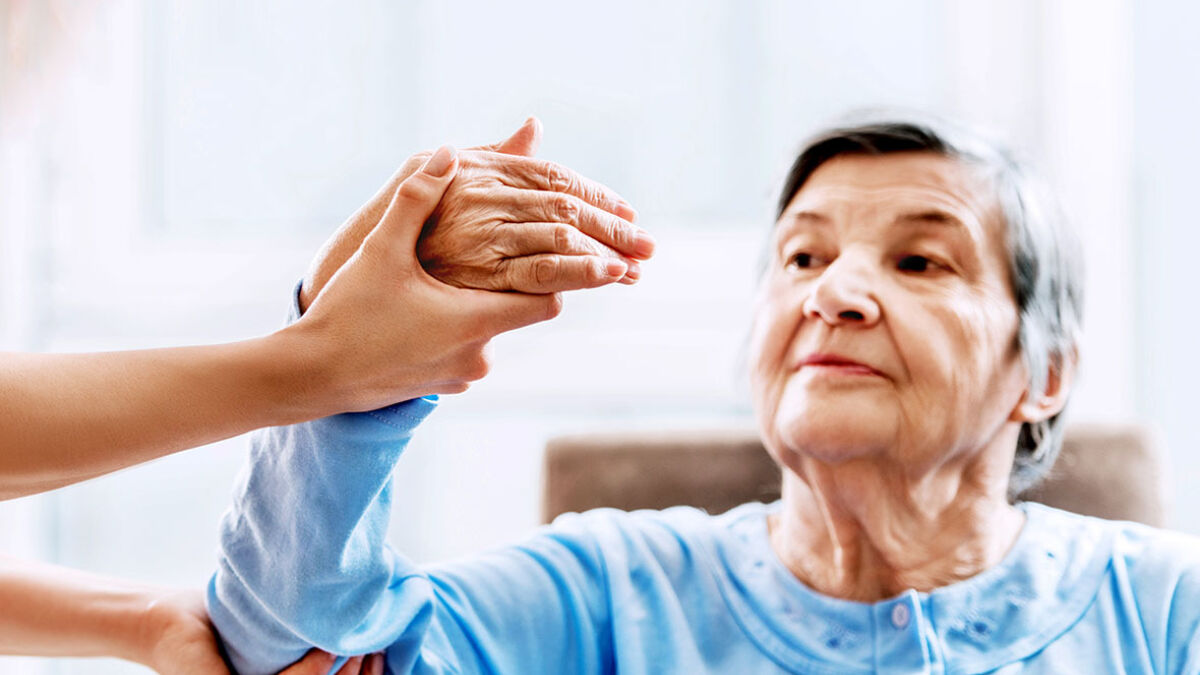 Older woman receiving hand therapy