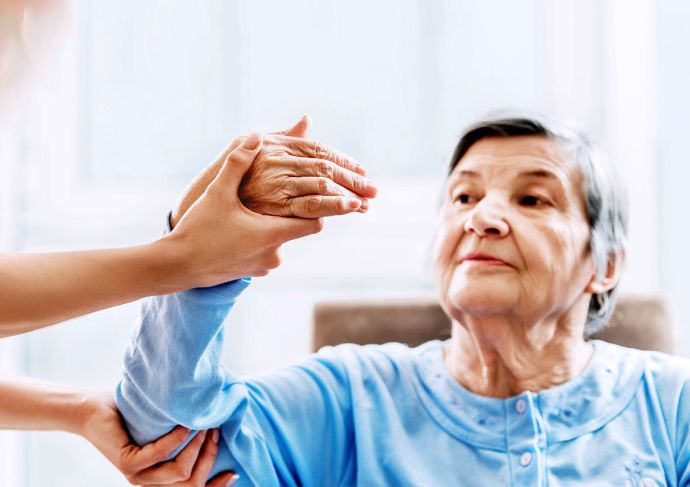 Older woman receiving hand therapy