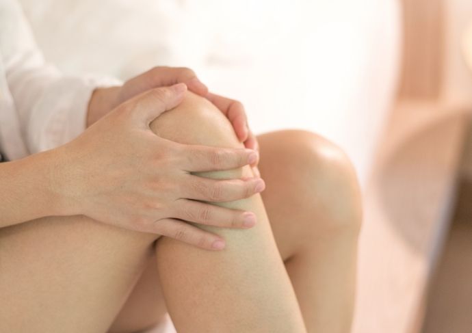 Woman rubbing her knee