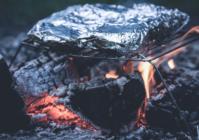 Foil packets on campfire