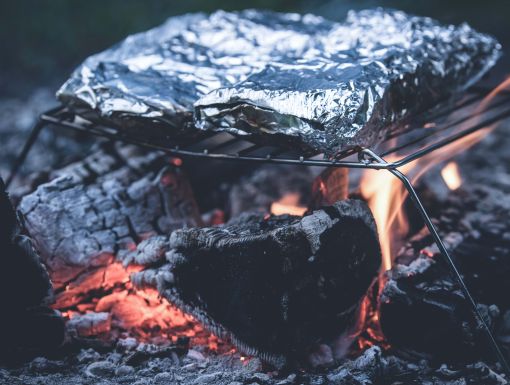 Foil packets on campfire