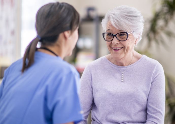 Happy Elderly Woman Talking with Healthcare Provider