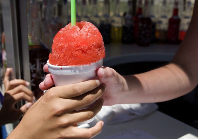 Red snowball being handed to someone through a window