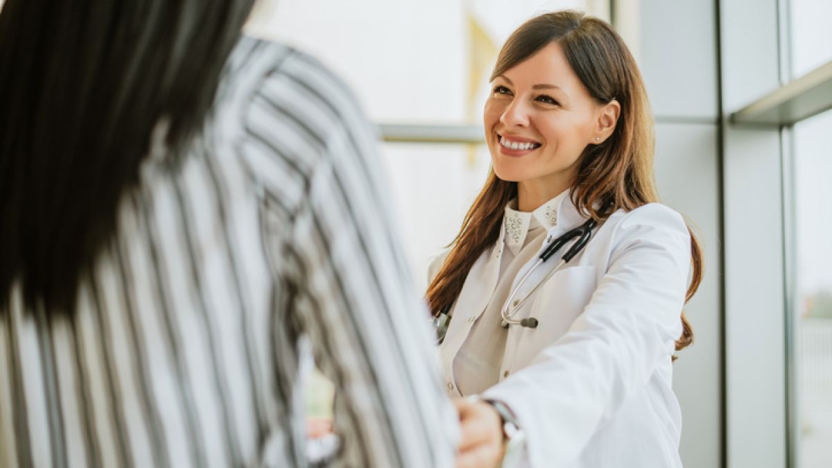 Female doctor smiling with patient