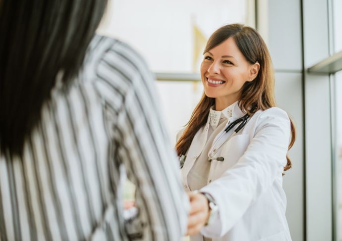 Female doctor smiling with patient