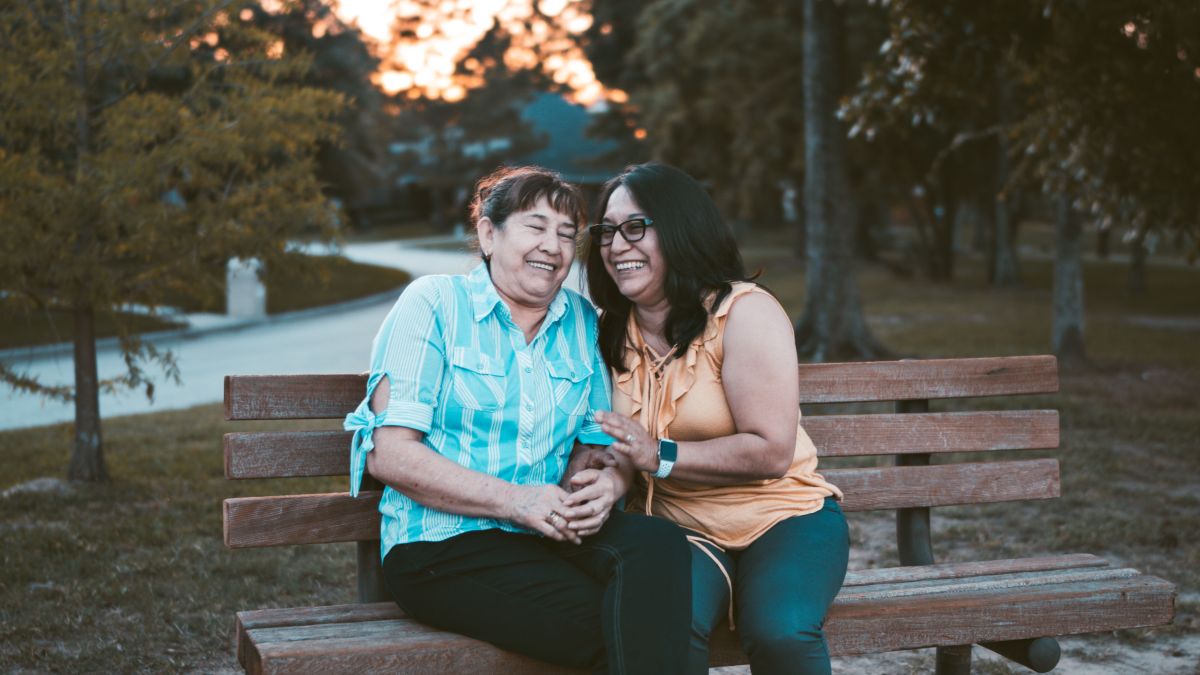 Older woman with daughter sitting on bench