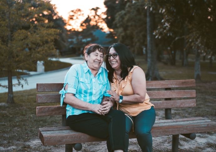 Older woman with daughter sitting on bench