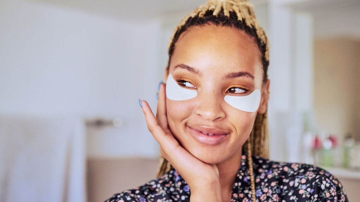 Woman using under eye patches