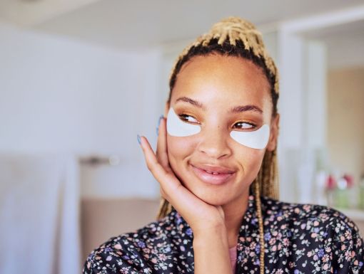 Woman using under eye patches