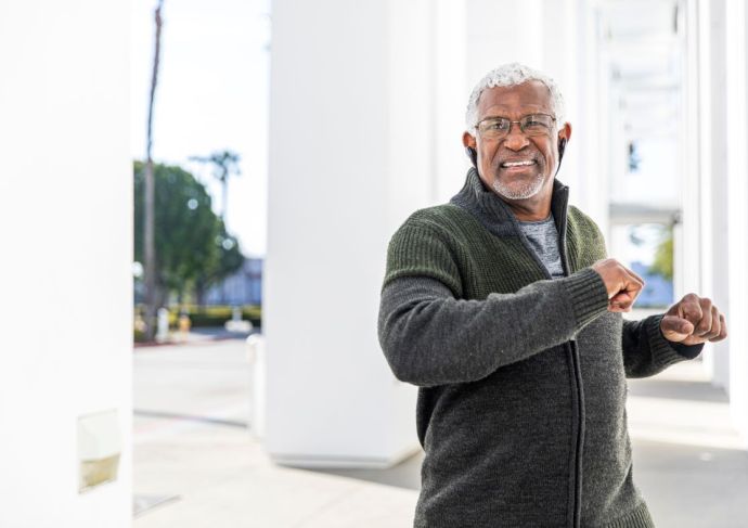 Older man preparing to exercise outdoors